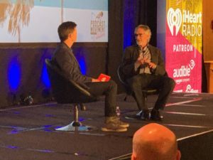 Conal Byrne (President, iHeartPodcast Network) chats onstage with Bob Pittman.